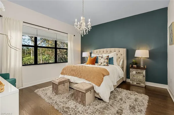 a bed sitting in a bedroom next to a window