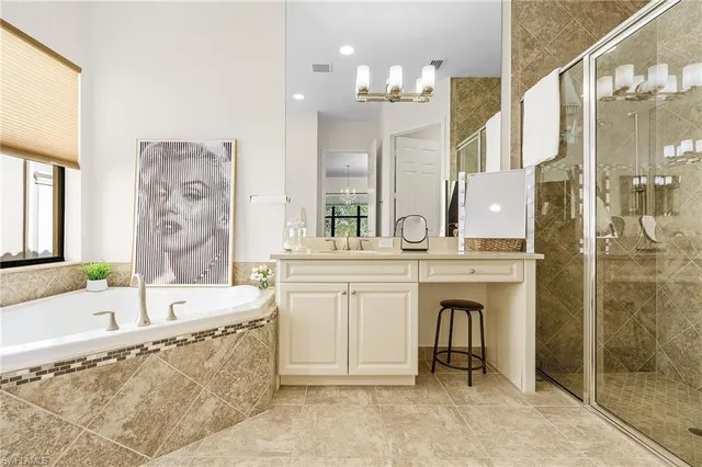 a bathroom with a tub a sink and a large mirror