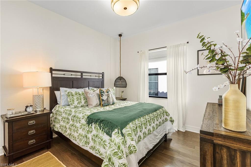 3063 Hudson Terrace Naples, FL 34119 - Photo 4 of 21 a bedroom with a bed and wooden floor