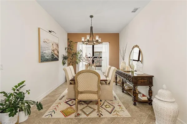 a living room with furniture a window and potted plant