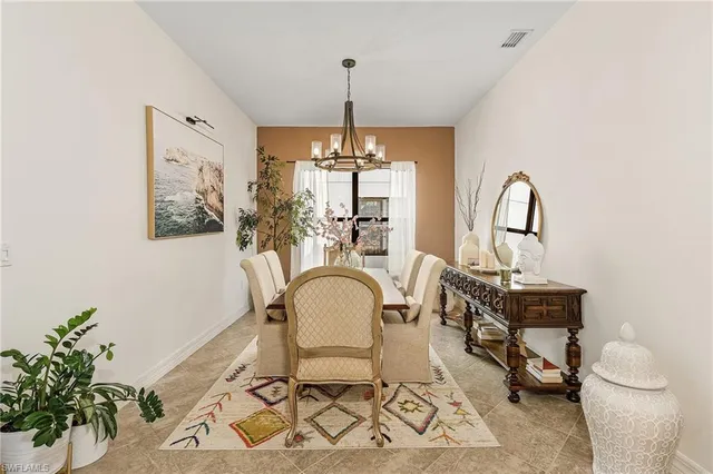 a living room with furniture a window and potted plant