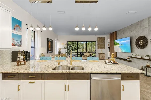 a kitchen with granite countertop kitchen island stainless steel appliances sink stove and microwave