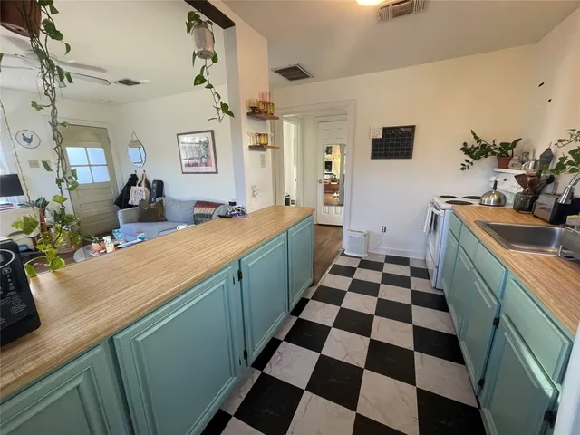 a kitchen with a sink and a stove top oven