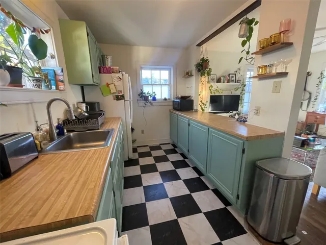 a kitchen with a sink and a stove top oven
