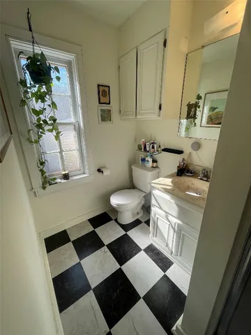 a bathroom with a sink toilet and a mirror
