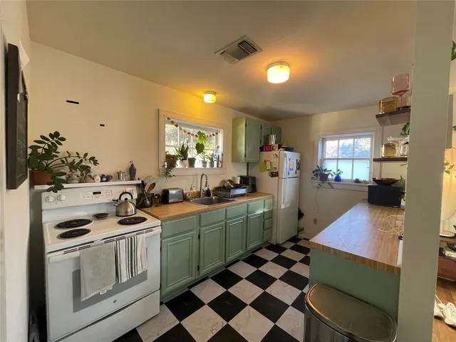 a kitchen that has a sink and a stove