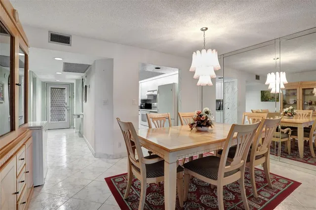 a car parked in front of a building with parked cars