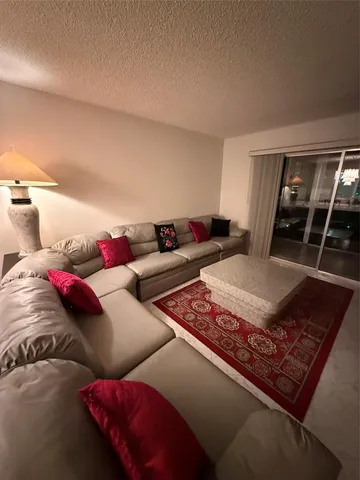 a view of a house with swimming pool and sitting area