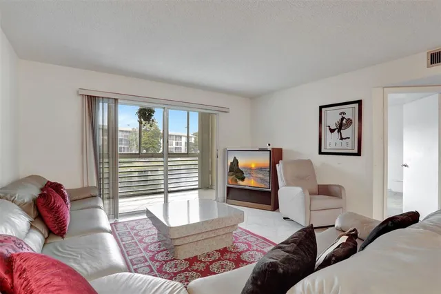 a open kitchen with stainless steel appliances granite countertop a stove top oven table and chairs