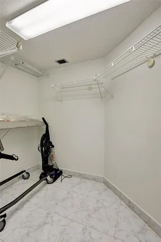 a bed room with a bed and a chair