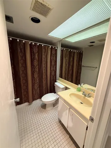 a room with pool table and windows