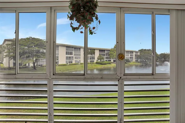 a kitchen with stainless steel appliances a stove top oven a sink a counter top space and cabinets