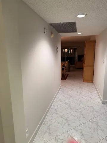 a kitchen with granite countertop a sink a stove and a refrigerator