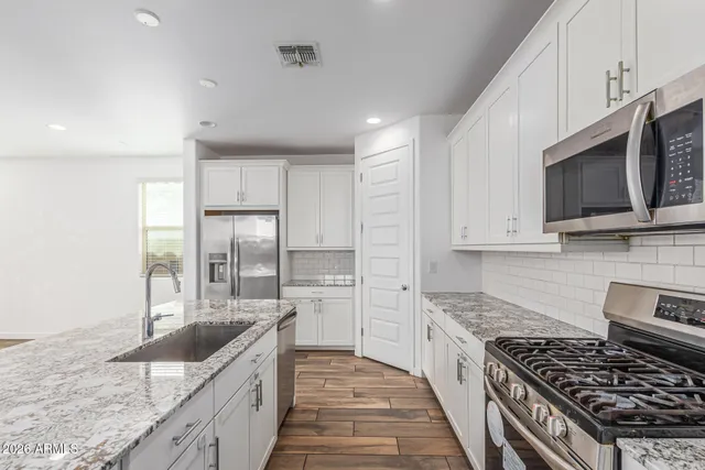 a bathroom with double sink and a large mirror