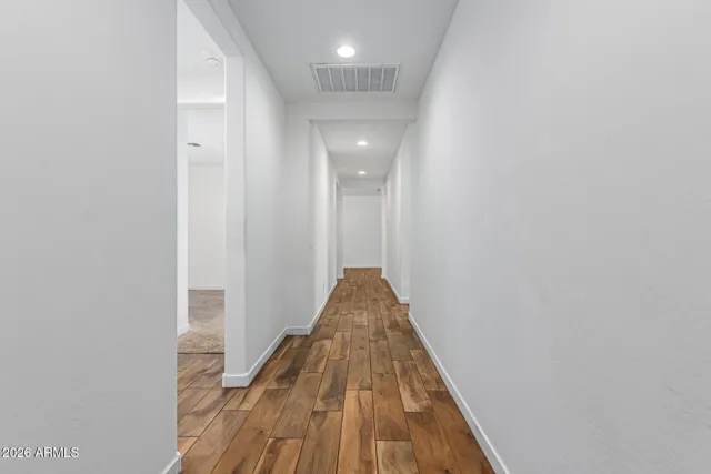 a view of an empty room with natural light