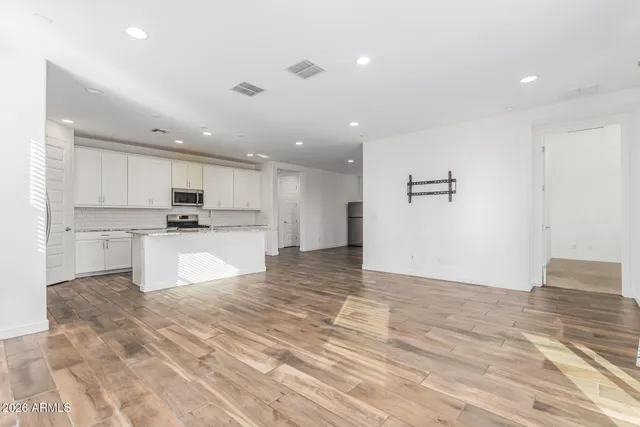 a kitchen with stainless steel appliances granite countertop a sink a refrigerator and a stove