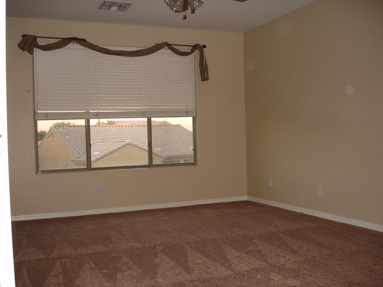 4744 East Timberline Road Gilbert, AZ 85297 - Photo 11 of 25 a view of empty room with wooden floor and windows