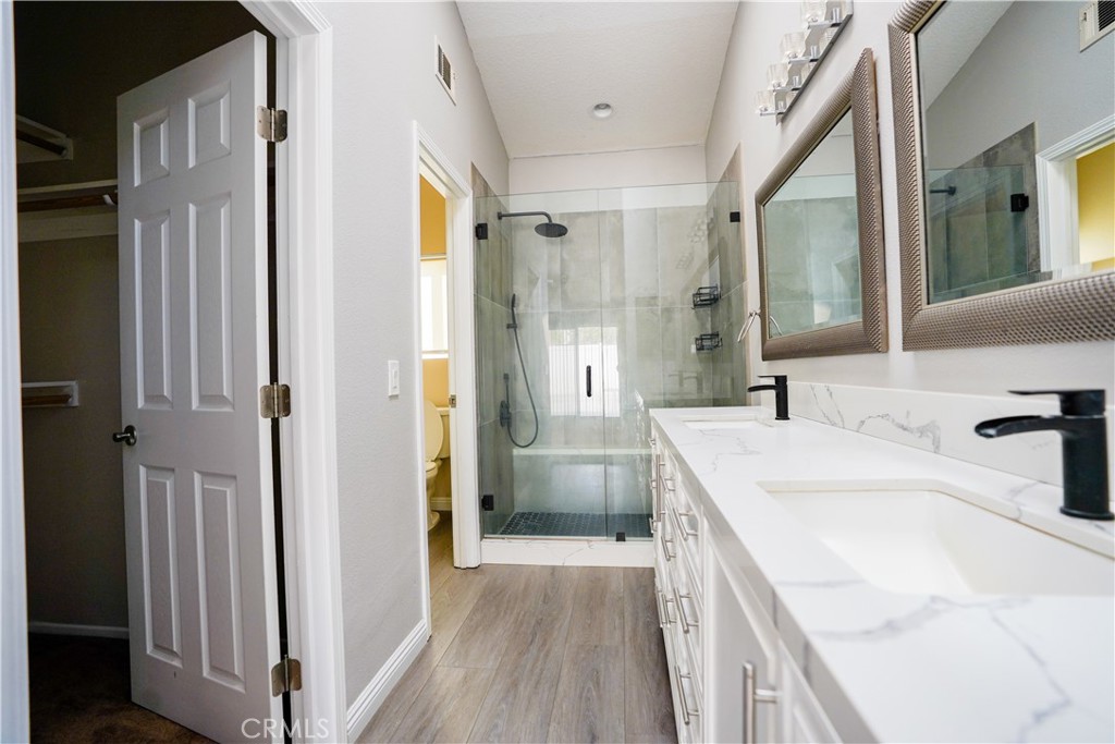 7562 Webster Street Highland, CA 92346 - Photo 13 of 30 a bathroom with a sink a toilet and shower