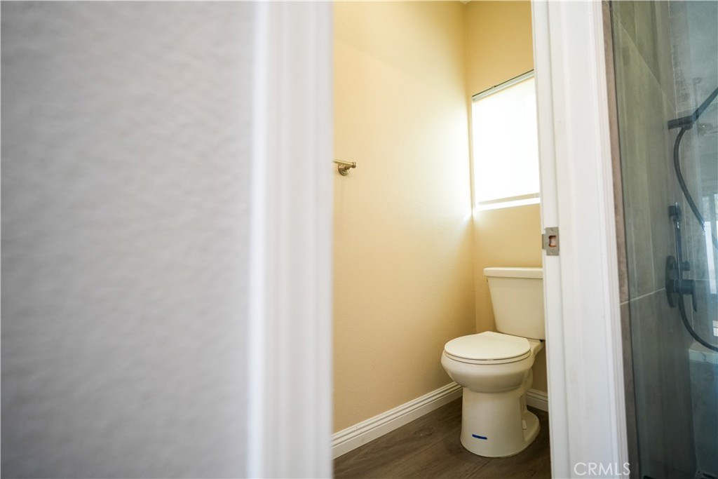 7562 Webster Street Highland, CA 92346 - Photo 15 of 30 a bathroom with a toilet and a sink