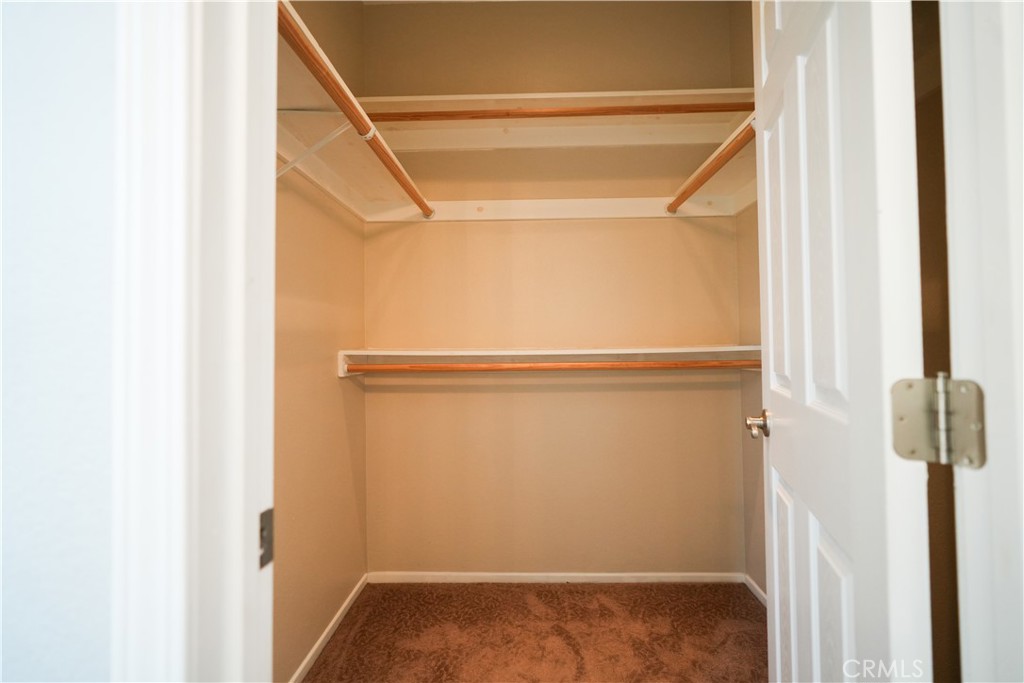 7562 Webster Street Highland, CA 92346 - Photo 16 of 30 a view of walk in closet with empty racks