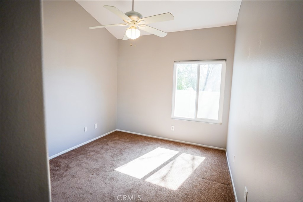 7562 Webster Street Highland, CA 92346 - Photo 20 of 30 an empty room with a window and ceiling fan
