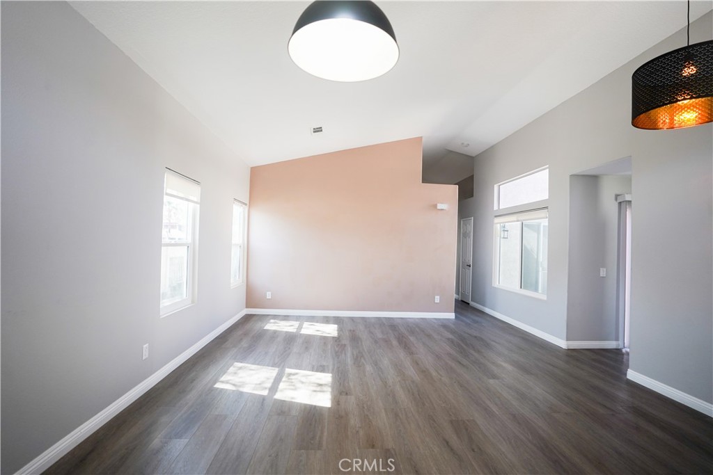 7562 Webster Street Highland, CA 92346 - Photo 21 of 30 an empty room with wooden floor and windows