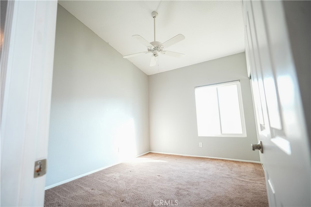 7562 Webster Street Highland, CA 92346 - Photo 23 of 30 an empty room with windows and ceiling fan