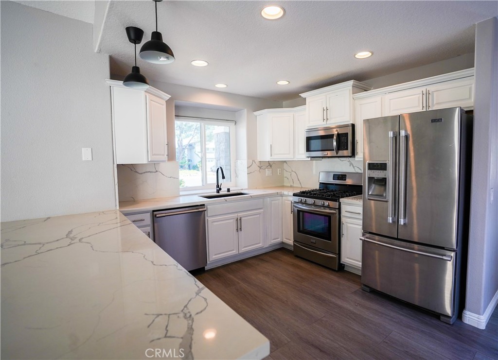 7562 Webster Street Highland, CA 92346 - Photo 6 of 30 a kitchen with kitchen island a counter space a sink appliances and cabinets