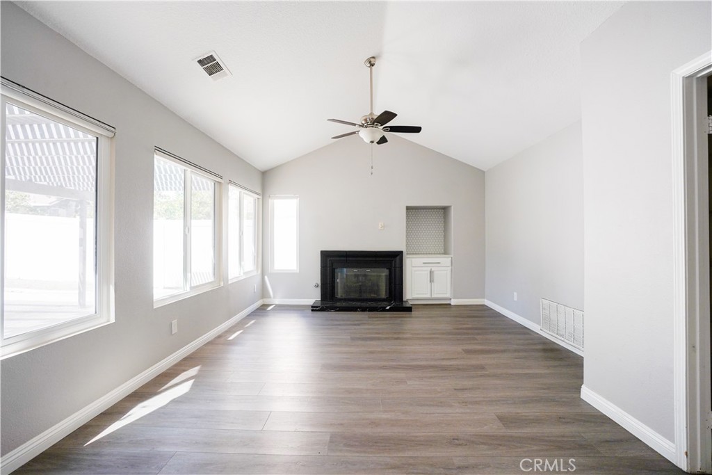 7562 Webster Street Highland, CA 92346 - Photo 9 of 30 an empty room with windows and fireplace