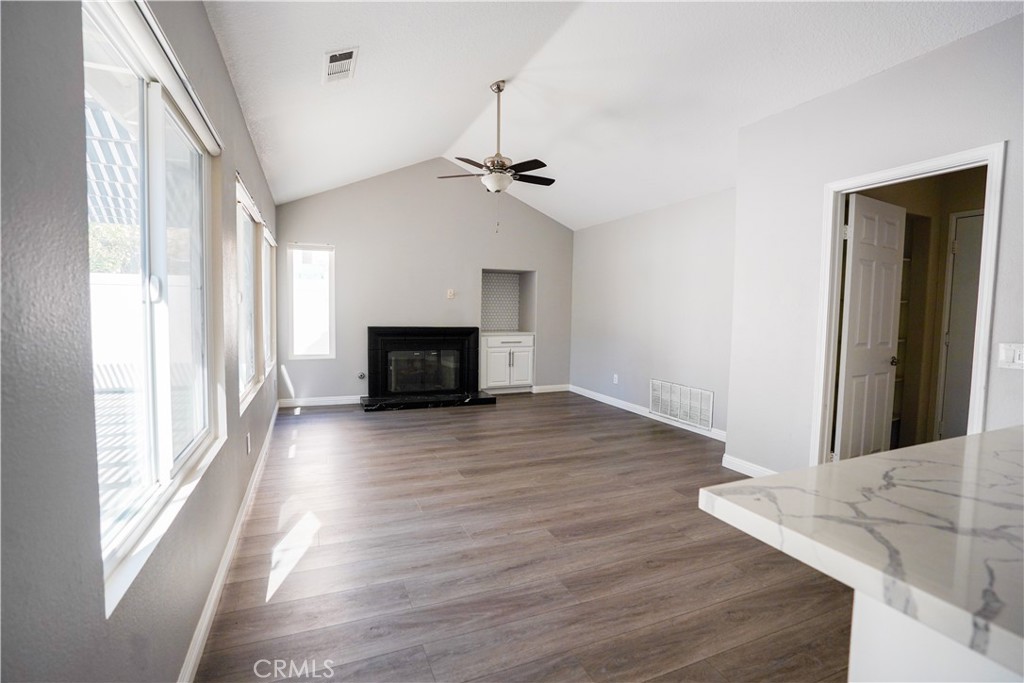 7562 Webster Street Highland, CA 92346 - Photo 10 of 30 a view of a livingroom with wooden floor and a ceiling fan