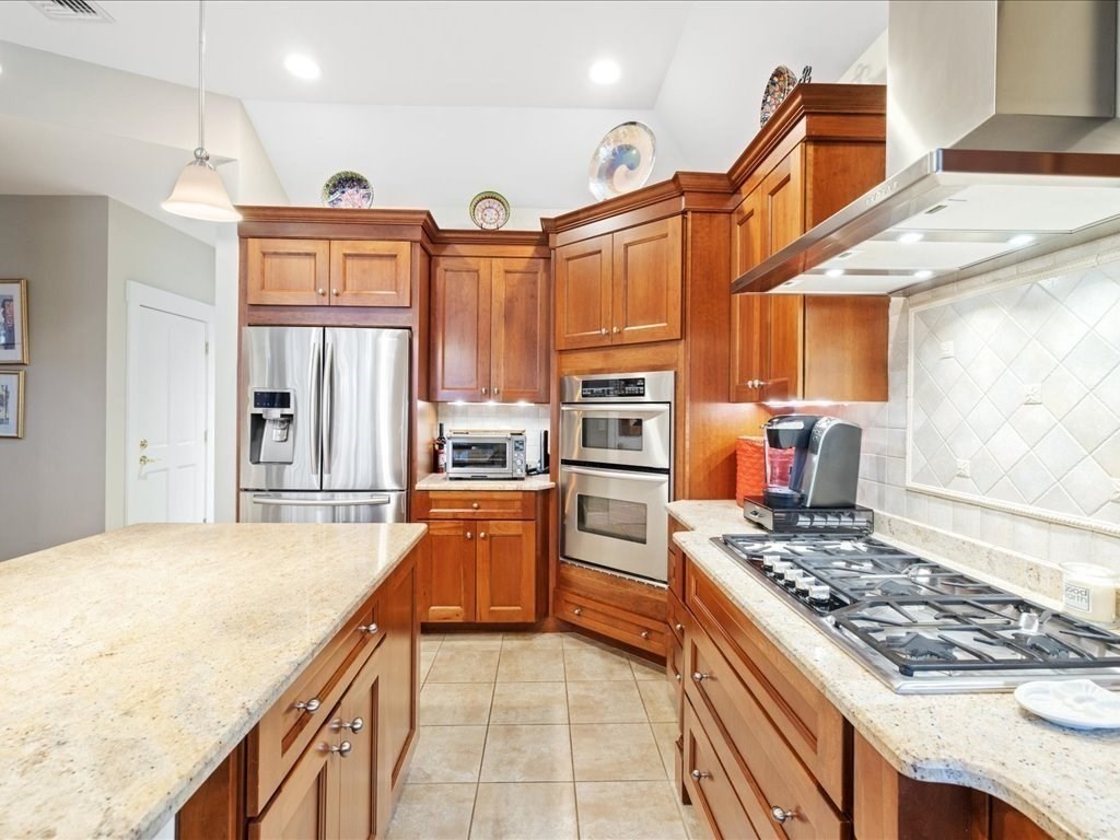 15 Cushing Hill Road Hanover, MA 02339 - Photo 17 of 42 a kitchen with stainless steel appliances granite countertop a stove top oven a sink dishwasher and cabinets with wooden floor