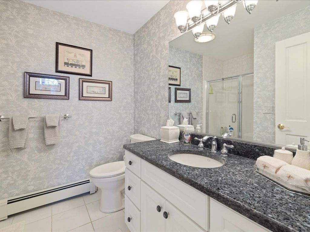 15 Cushing Hill Road Hanover, MA 02339 - Photo 29 of 42 a bathroom with a granite countertop sink a toilet and a mirror