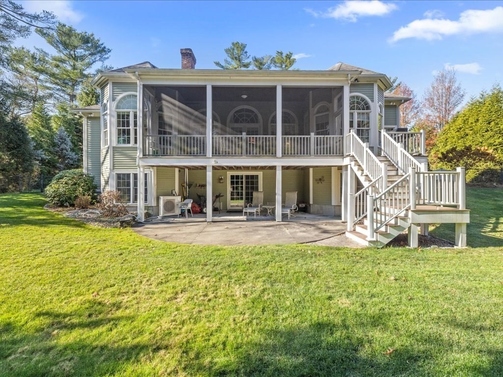 15 Cushing Hill Road Hanover, MA 02339 - Photo 4 of 42 a front view of a house with a yard table and chairs