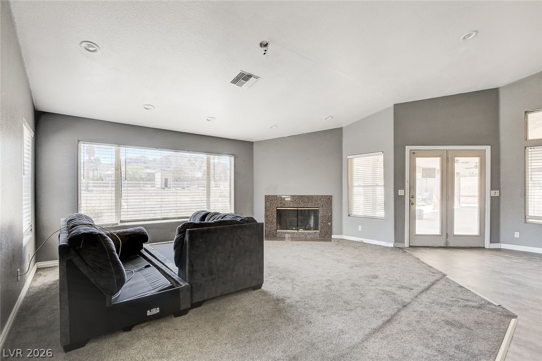 631 Lomprey Avenue Henderson, NV 89002 - Photo 61 of 99 Family room boasts access to the rear covered patio & overlooks this palatial estate to the south. Vaulted ceiling, recessed lighting & cozy fireplace complete this room.