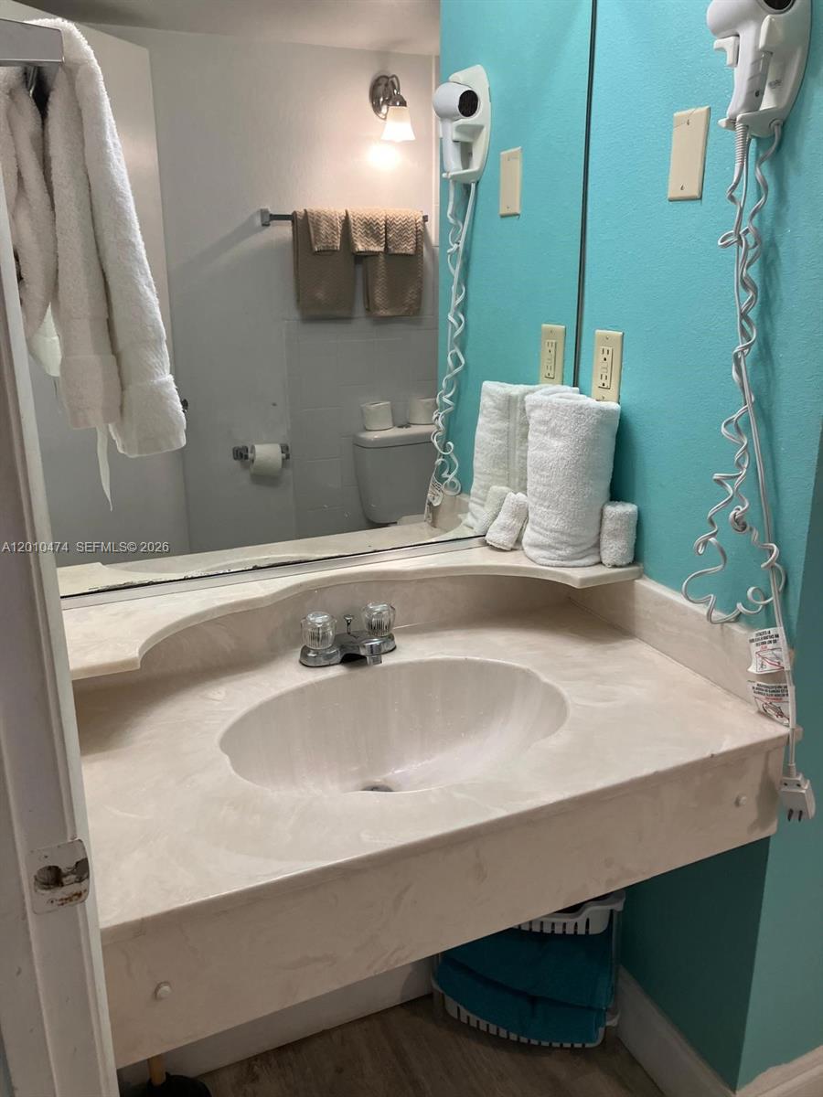 1909 South Atlantic Avenue, Unit 803804 Daytona Beach, FL 32118 - Photo 15 of 43 a bathroom with a sink and a mirror