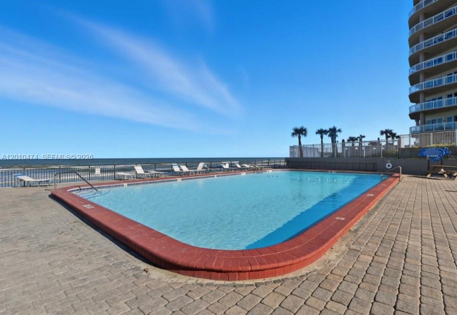 1909 South Atlantic Avenue, Unit 803804 Daytona Beach, FL 32118 - Photo 2 of 43 a view of a swimming pool with a yard