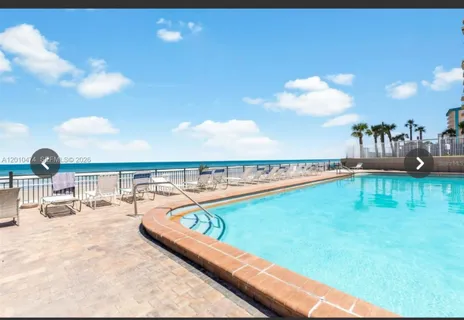 a view of a swimming pool with furniture