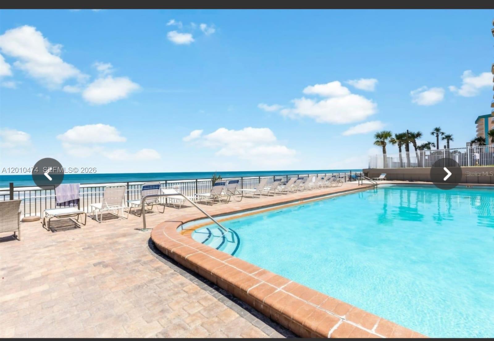 1909 South Atlantic Avenue, Unit 803804 Daytona Beach, FL 32118 - Photo 26 of 43 a view of a swimming pool with a terrace
