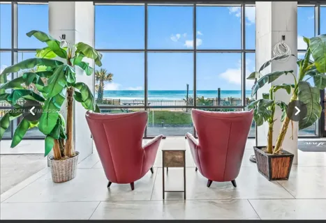 a view of a living room with furniture and potted plant