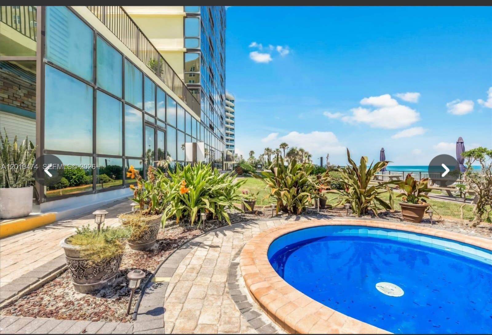 1909 South Atlantic Avenue, Unit 803804 Daytona Beach, FL 32118 - Photo 34 of 43 a view of a swimming pool with outdoor seating