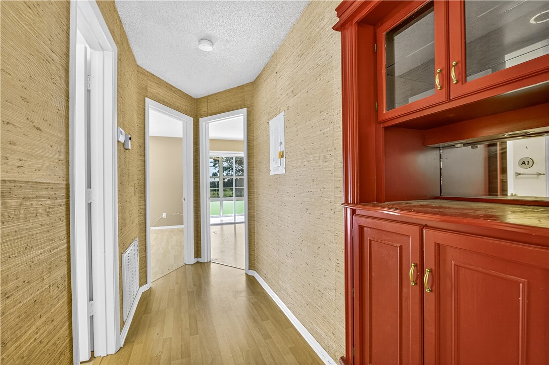 45 Vista Gdns Trail, Unit 202 Vero Beach, FL 32962 - Photo 14 of 32 a view of a hallway with wooden floor and entryway