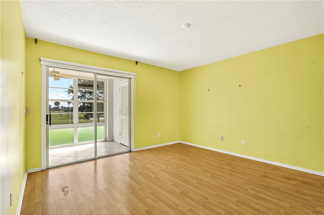 45 Vista Gdns Trail, Unit 202 Vero Beach, FL 32962 - Photo 15 of 32 a view of empty room with wooden floor