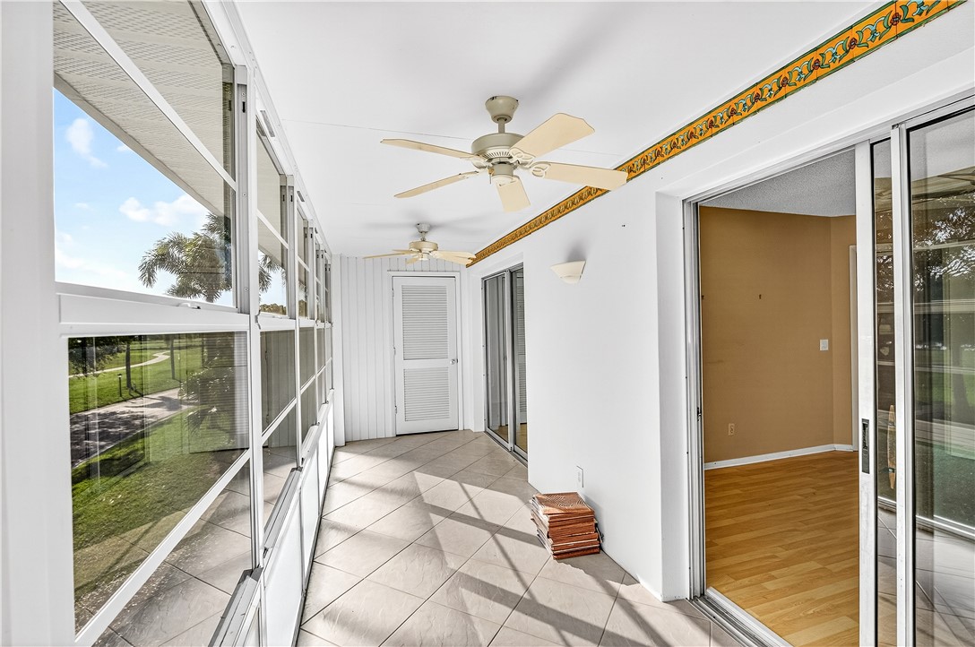 45 Vista Gdns Trail, Unit 202 Vero Beach, FL 32962 - Photo 21 of 32 a porch with a glass door shower and yard