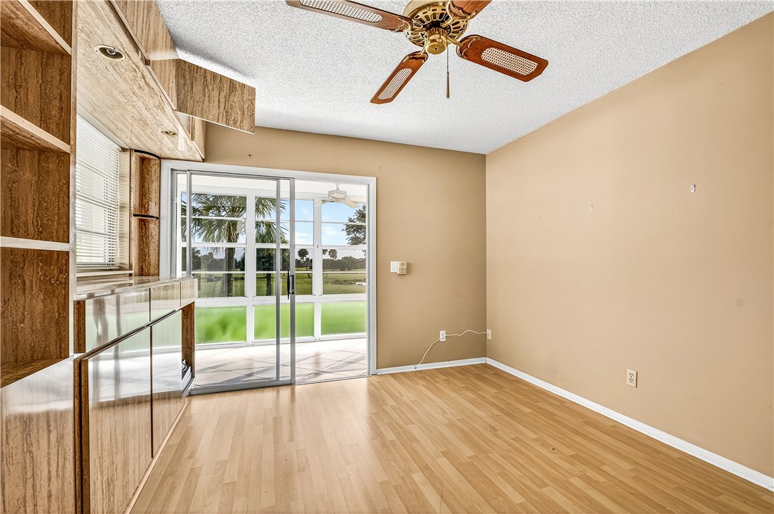45 Vista Gdns Trail, Unit 202 Vero Beach, FL 32962 - Photo 23 of 32 a view of empty room with wooden floor and fan