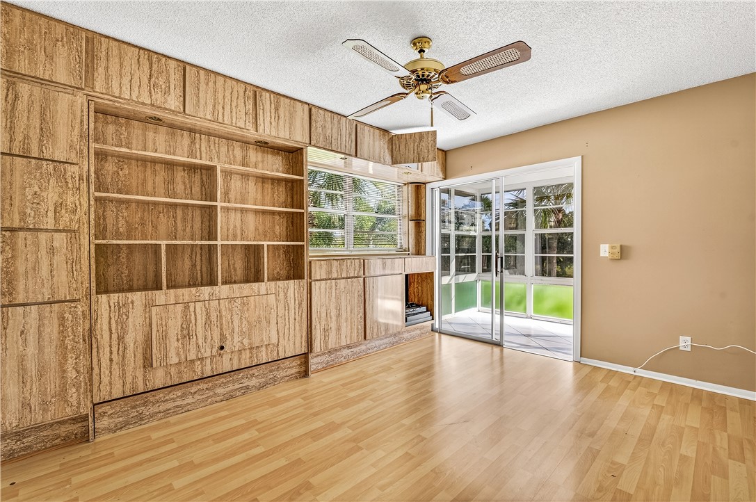 45 Vista Gdns Trail, Unit 202 Vero Beach, FL 32962 - Photo 24 of 32 wooden floor in an empty room with a window
