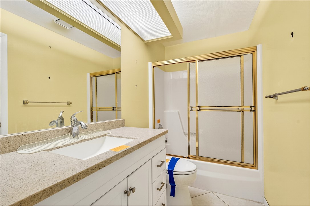45 Vista Gdns Trail, Unit 202 Vero Beach, FL 32962 - Photo 26 of 32 a bathroom with a sink and a mirror