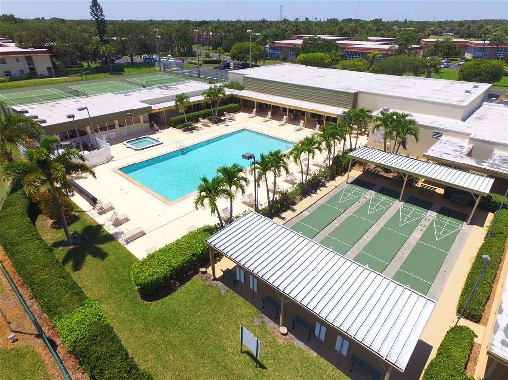 45 Vista Gdns Trail, Unit 202 Vero Beach, FL 32962 - Photo 28 of 32 a view of a swimming pool with a patio
