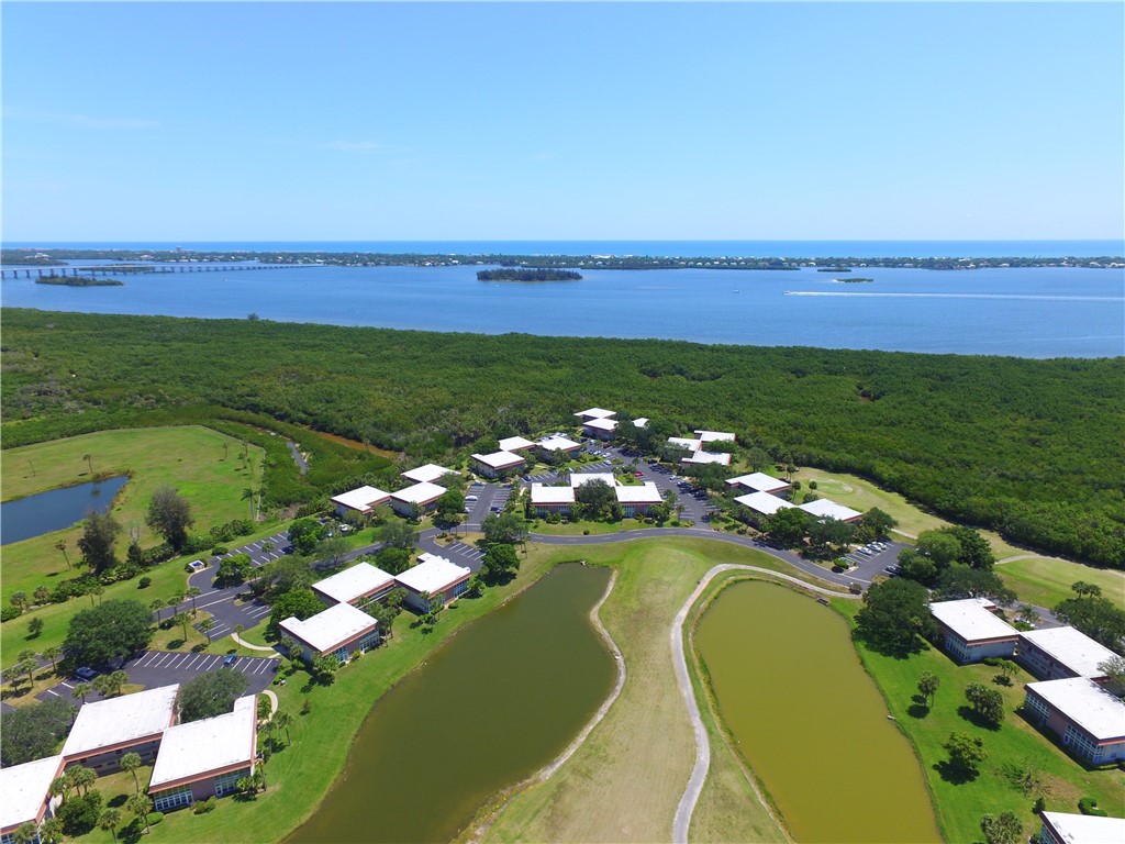45 Vista Gdns Trail, Unit 202 Vero Beach, FL 32962 - Photo 31 of 32 an aerial view of a houses with a swimming pool