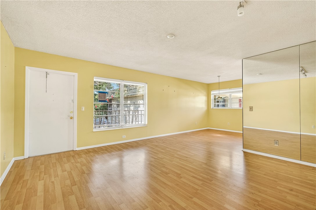 45 Vista Gdns Trail, Unit 202 Vero Beach, FL 32962 - Photo 5 of 32 a view of an empty room with wooden floor and a window