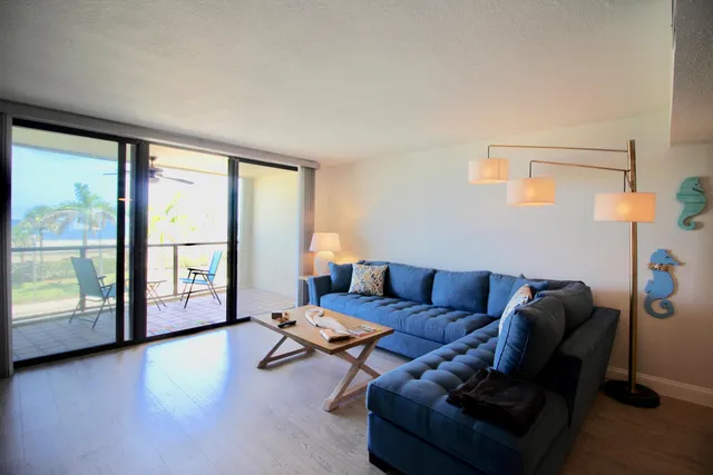 a view of a lake from a balcony with seating space